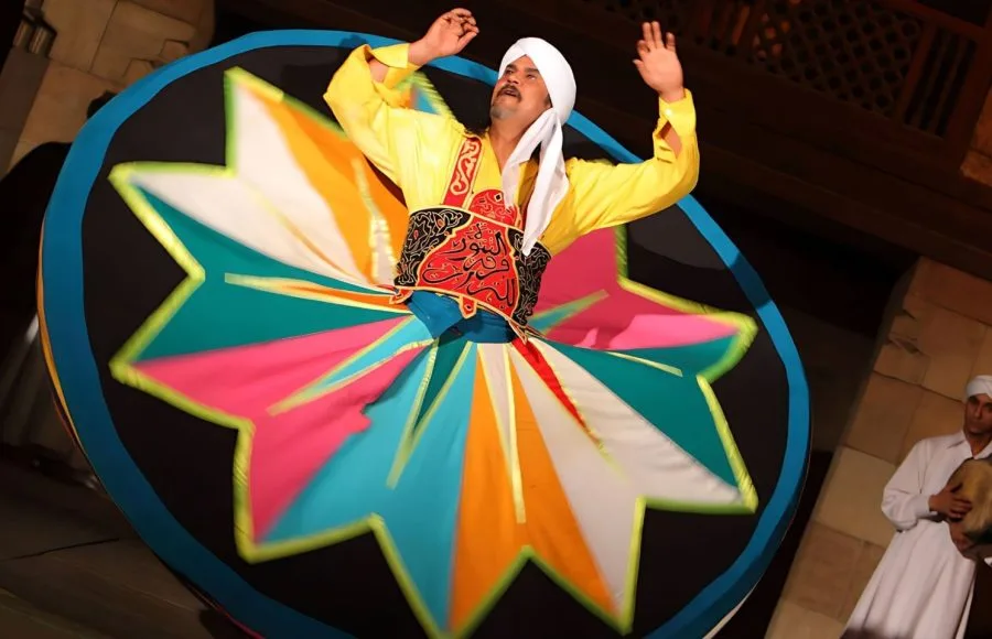 Close-up of a Tanoura dancer's vibrant star-patterned skirt in mid-spin.