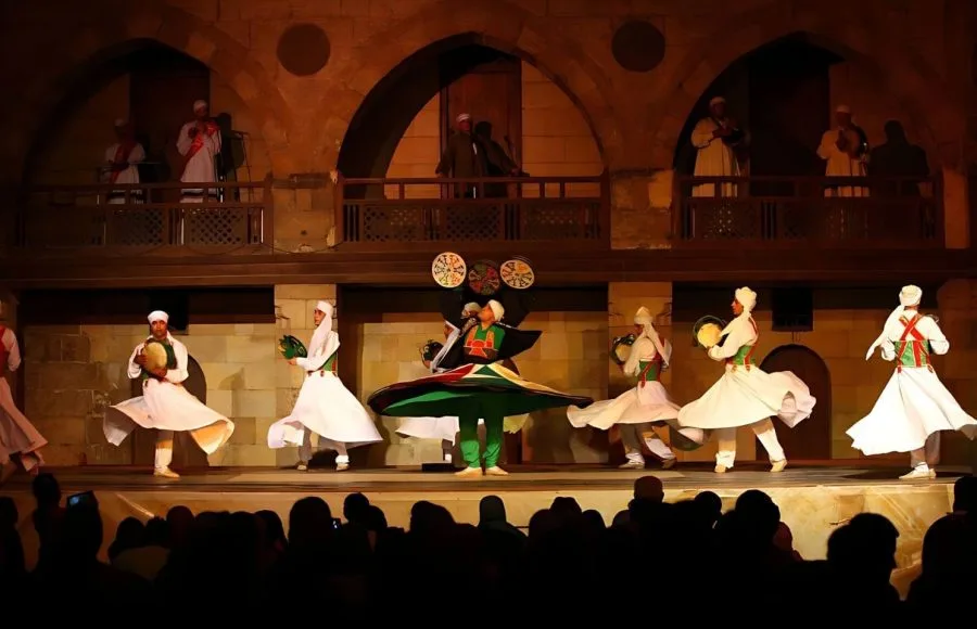 Performers in white robes dancing the Tanoura at Wekalet El Ghouri.