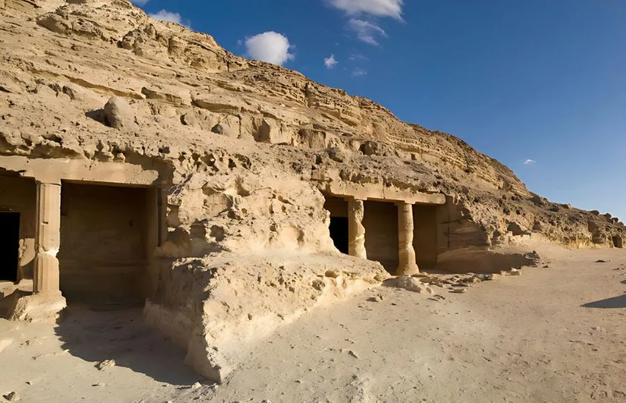 Panoramic view of multiple Middle Kingdom rock-cut tombs carved into the cliff face at Beni Hasan, Egypt.