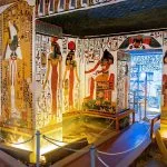 The brightly decorated walls and ceiling of the Tomb of Nefertari decorated with colorful paintings in the Valley of the Queens, showing ancient Egyptian deities and hieroglyphs in rich detail.