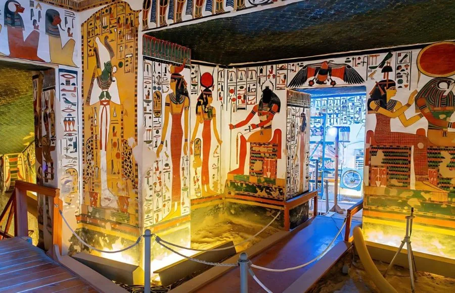 The brightly decorated walls and ceiling of the Tomb of Nefertari decorated with colorful paintings in the Valley of the Queens, showing ancient Egyptian deities and hieroglyphs in rich detail.