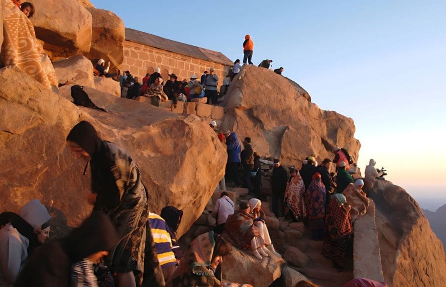 many-Tourists-looking-down-from-Mount-Sinai-at-sunrise-Egypt