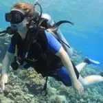 A-female-With-scuba-diving-passes-near-a-coral-reef-in-Hurghada