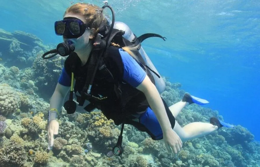 A-female-With-scuba-diving-passes-near-a-coral-reef-in-Hurghada