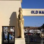 The entrance gate to the 'Old Market' in Sharm El Sheikh, flanked by golden pharaonic statues.