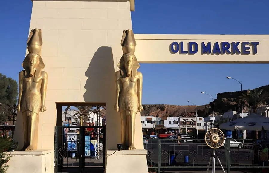 The entrance gate to the 'Old Market' in Sharm El Sheikh, flanked by golden pharaonic statues.