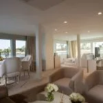 Interior view of the lounge area on the Kazazian Berge Dahabiya luxury yacht, featuring modern furnishings and large windows overlooking the Nile.