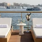 Kazazian Berge Dahabiya Sun Deck with two lounge chairs and river view.