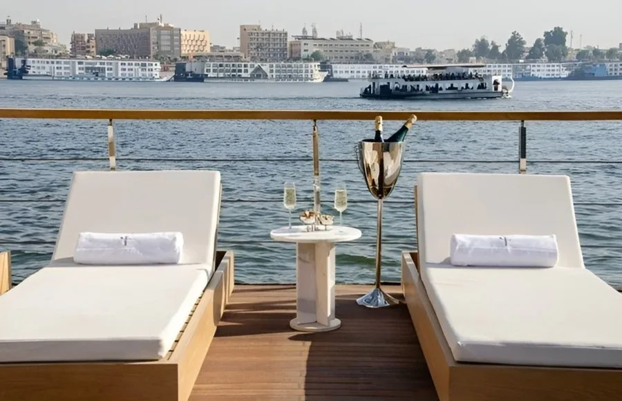 Kazazian Berge Dahabiya Sun Deck with two lounge chairs and river view.