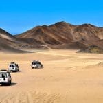 Landscape-Of-Sahara-Desert-With-Jeeps-For-Safari