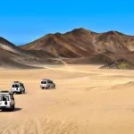 Landscape-Of-Sahara-Desert-With-Jeeps-For-Safari