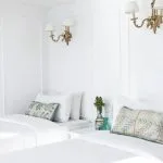 Lazuli Abydos Dahabiya Nile Cruise cabin with twin beds, white linens, and light-colored walls.