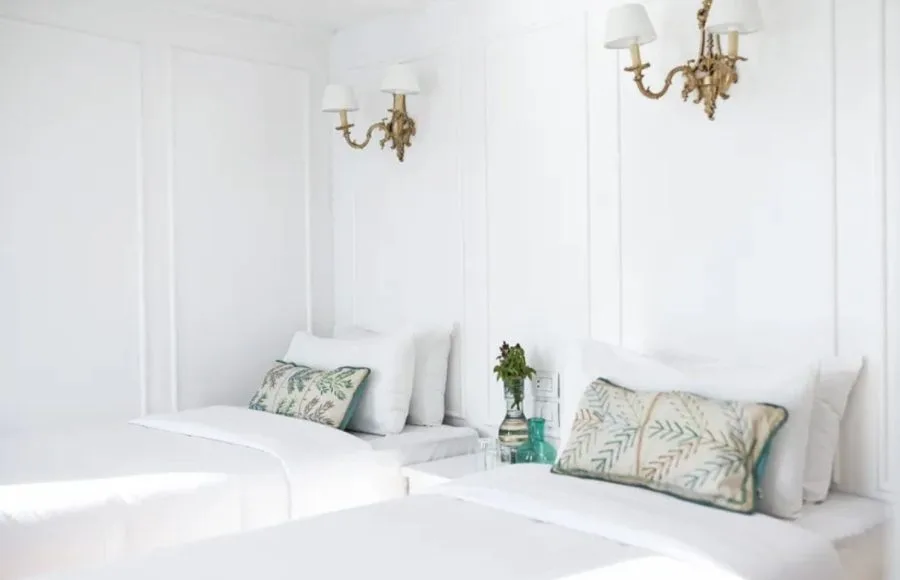 Lazuli Abydos Dahabiya Nile Cruise cabin with twin beds, white linens, and light-colored walls.