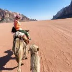 Tourist-woman-in-traditional-arabian-clothes-with-camel-in-Sharm-el-Sheikh