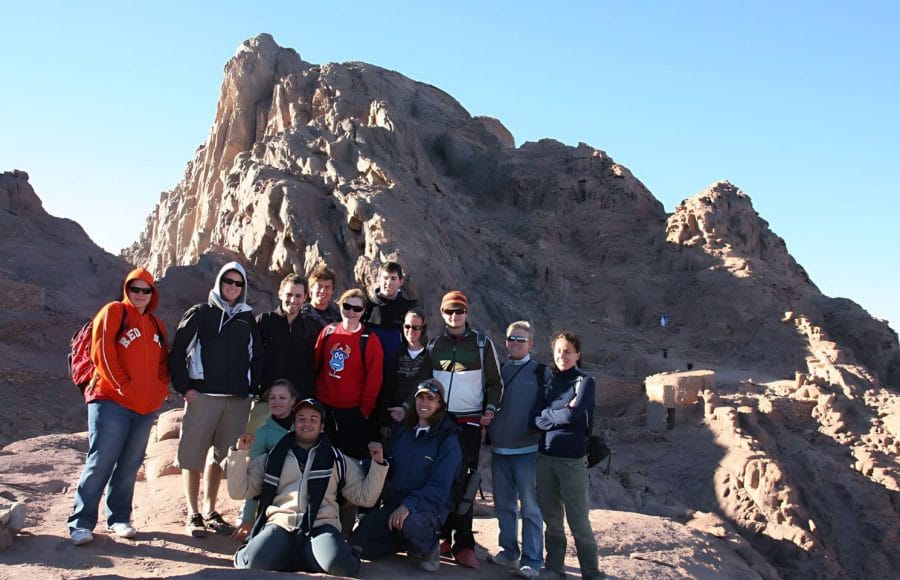 Western-tour-group-people-in-early-morning-after-sunrise-climb-walk-on-Mount-Sinai