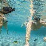 Young-couple-snorkeling-selfie-with-underwater-camera-on-the-coral-reef-Hurghada