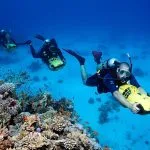 Divers-With-Diver-Propulsion-Vehicles-Exploring-Coral-Reef-Soma-Bay-Hurghada-Egypt