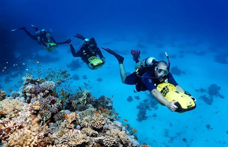 Divers-With-Diver-Propulsion-Vehicles-Exploring-Coral-Reef-Soma-Bay-Hurghada-Egypt