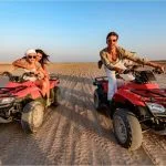 Happy-Tourists-Driving-Quads-In-Makadi-Bay-Desert