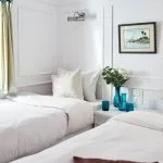 A twin cabin on the Lazuli Roi Farouk Dahabiya Nile Cruise with two single beds and Nile views.