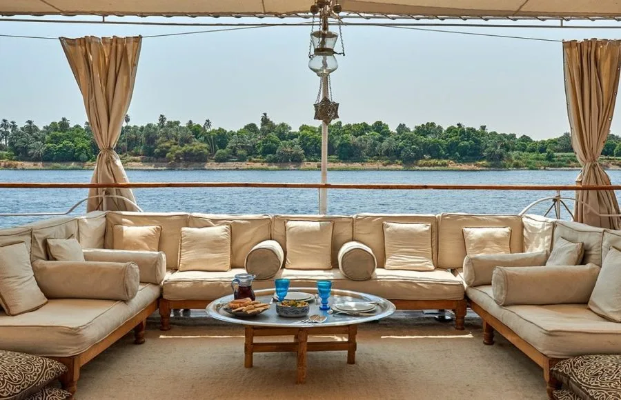 Lazuli Roi Farouk Dahabiya Nile Cruise sun deck with comfortable seating and views of the Nile River landscape.