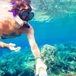 Man-Snorkeling-with-fish-and-coral-reef-Safaga