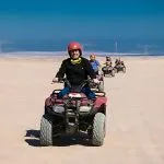 Tourists-In-Safari-Trip-Through-Makadi-Bay-Desert-Driving-Quad-Bike