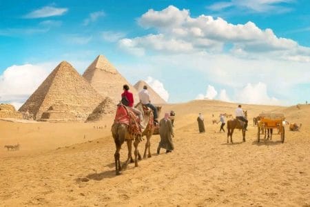 Tourists Riding Camels Near The Pyramids Of Giza A Thrilling Start To The 3 Day Cairo Luxor &Amp;Amp; Abu Simbel Short Break Tour