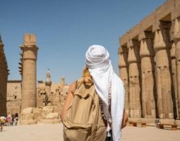 Tourist wearing a headscarf exploring Luxor Temple, part of 4 days in Egypt itinerary.