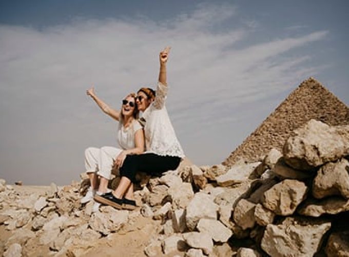 Two Happy Tourists At The Giza Pyramids, Part Of A Cairo And Nile Cruise 6 Days Itinerary.