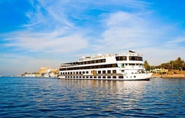 A Nile cruise ship sailing on the river, a highlight to your 8 Day Egypt Itinerary with Hurghada.
