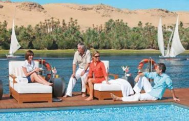 Seniors relaxing by a pool on a Nile cruise ship deck during a 9 Day Senior Egypt Tour with Nile Cruise.