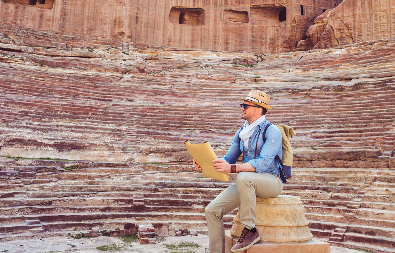 A Fashionable Tourist Exploring The Sights Of The Ancient Fabulous City Of Petra In Jordan