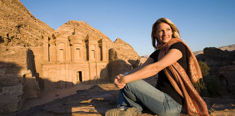 A Woman Tourist Visits The Nabatean Ruins Of The Monastery At Petra Jordan