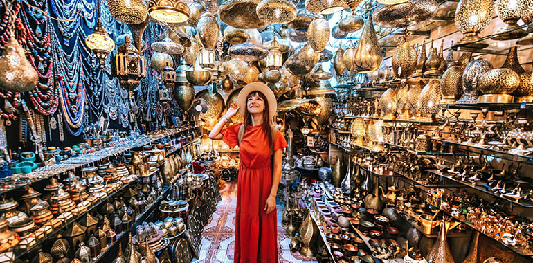 A Young traveling woman visiting a copper souvenir handicraft shop in Marrakesh