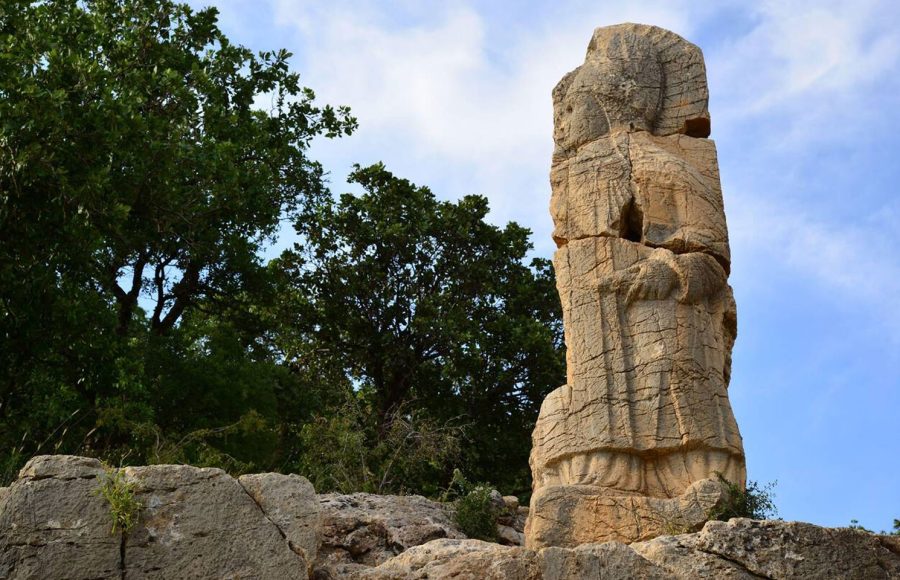 A-closeup-of-a-stone-statue-against-a-blue-sky-in-the-historic-Arsameia-Turkey