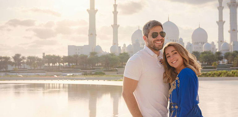 A Couple Visiting The Grand Mosque In Abu Dhabi United Arab Emarits