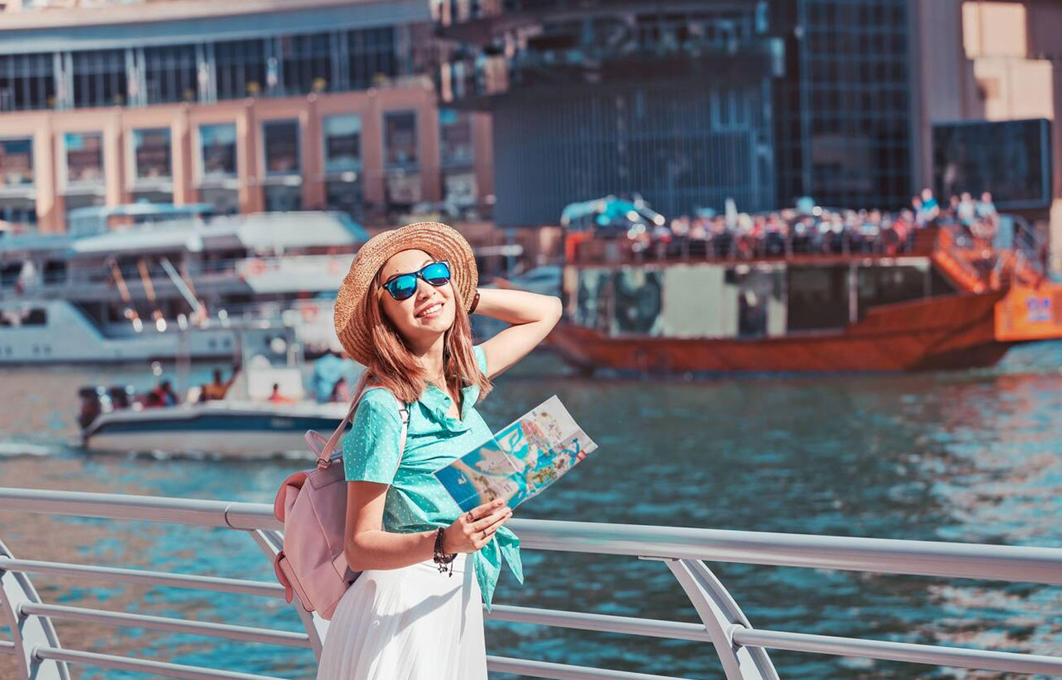 A Happy Traveller Girl With A Map Is Waiting For Her Cruise Ship At The Marina Port In Dubai