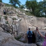 A-lady-takes-a-photo-of-the-stone-carved-statue-at-Arsameia-in-eastern-Turkey-depicting-King-Antiochus-shaking-hands-with-Hercules