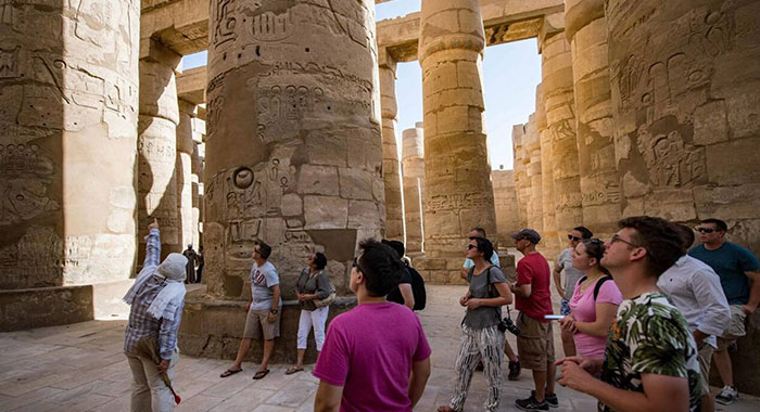 A Small Group Of Tourist With Their Tour Guide At Karnak Temple
