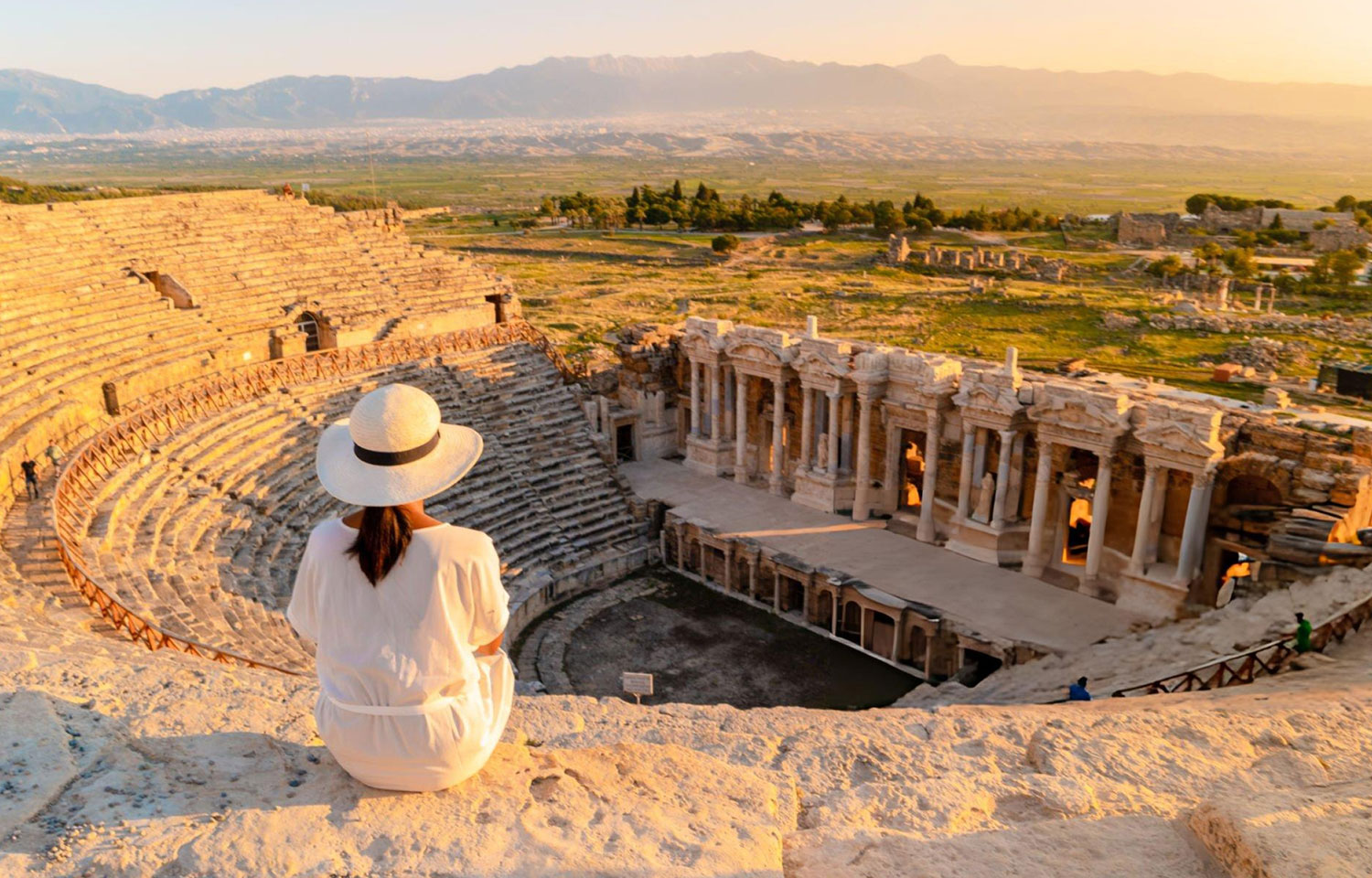 A young woman with hat watching sunset at the Hierapolis ancient city Pamukkale Turkey