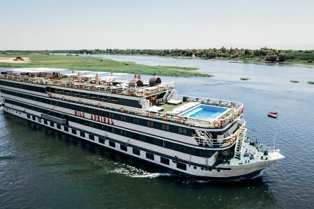 Nile Cruise Ship &Amp;Quot;Nile Admiral&Amp;Quot; Sailing On The Nile River Under A Clear Sky, Featuring An Upper Deck Swimming Pool And Sun Loungers.