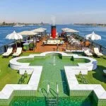Aerial view of the stunning swimming pool and sun deck on the historic SS Misr Nile Cruise luxury steamer navigating the Nile River.