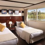 Luxury boat cabin with twin beds and a large window