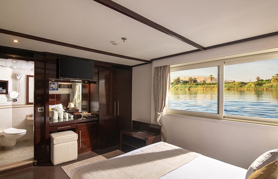Interior boat cabin showing the vanity, TV, and en-suite bathroom.