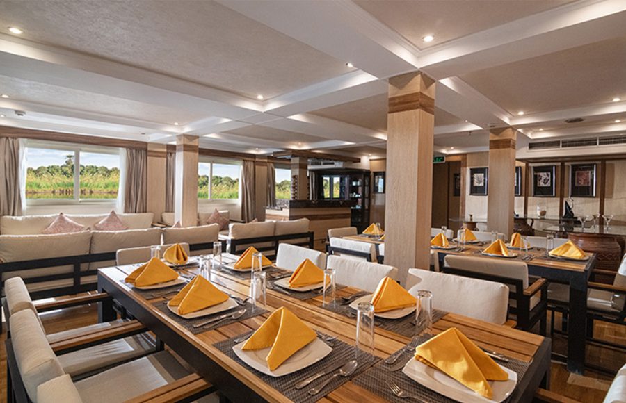 Interior restaurant area of the boat with set dining tables