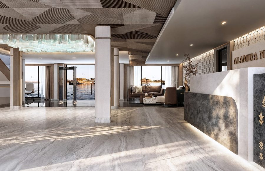 Modern cruise ship bar and lounge area with wood paneling, open shelves, and multi-colored velvet seating.