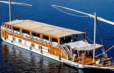High-angle view of a traditional twin-masted Dahabiya sailing boat on the blue Nile.