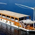 High-angle view of a traditional twin-masted Dahabiya sailing boat on the blue Nile.
