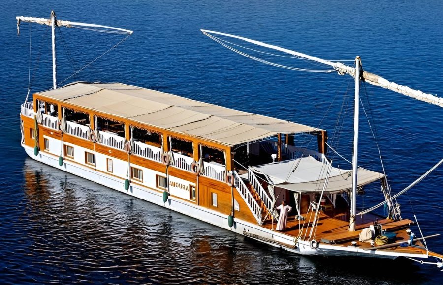 High-angle view of a traditional twin-masted Dahabiya sailing boat on the blue Nile.